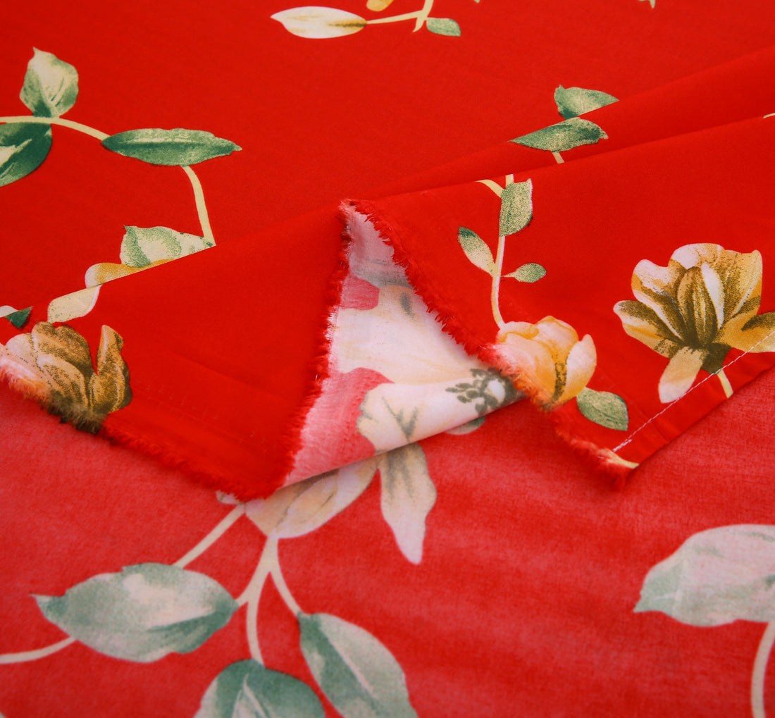 Red floral bedding set on a bed with a white background