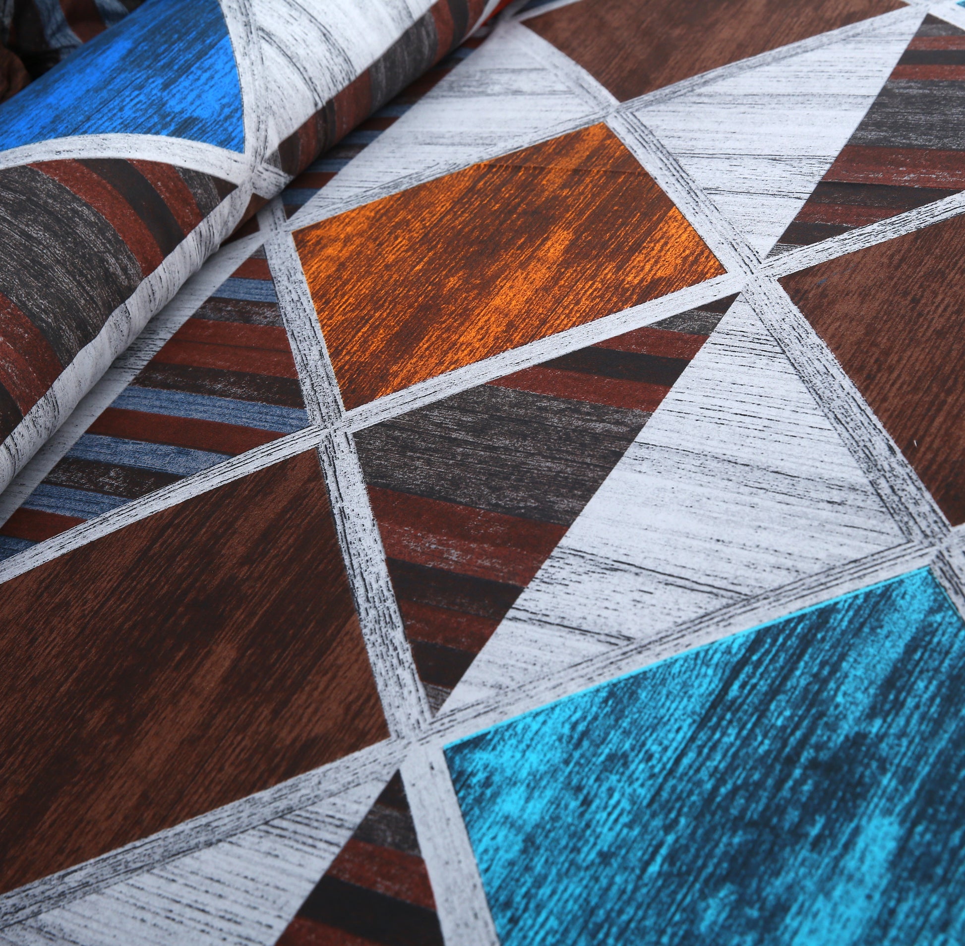 Close-up of a fabric with geometric pattern in brown, blue, and gray.