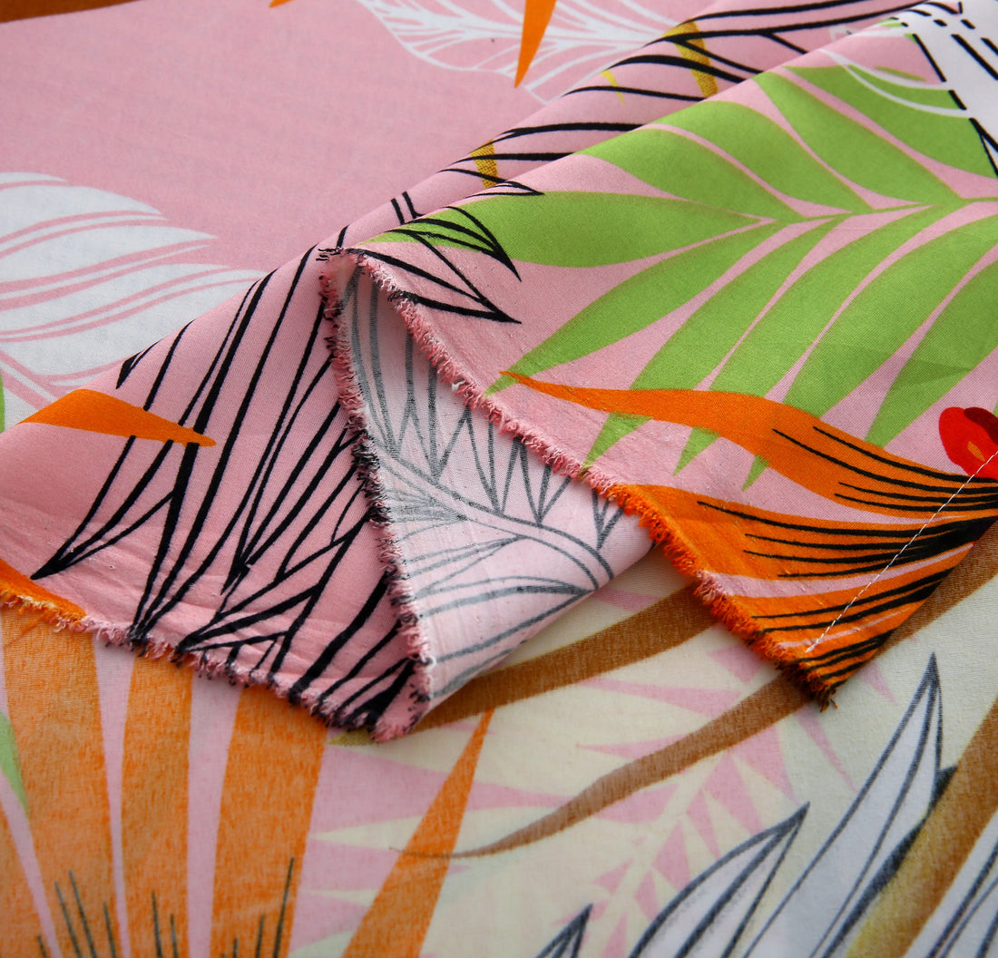 Tropical leaf patterned bedding set on a bed with a colorful headboard and decor.