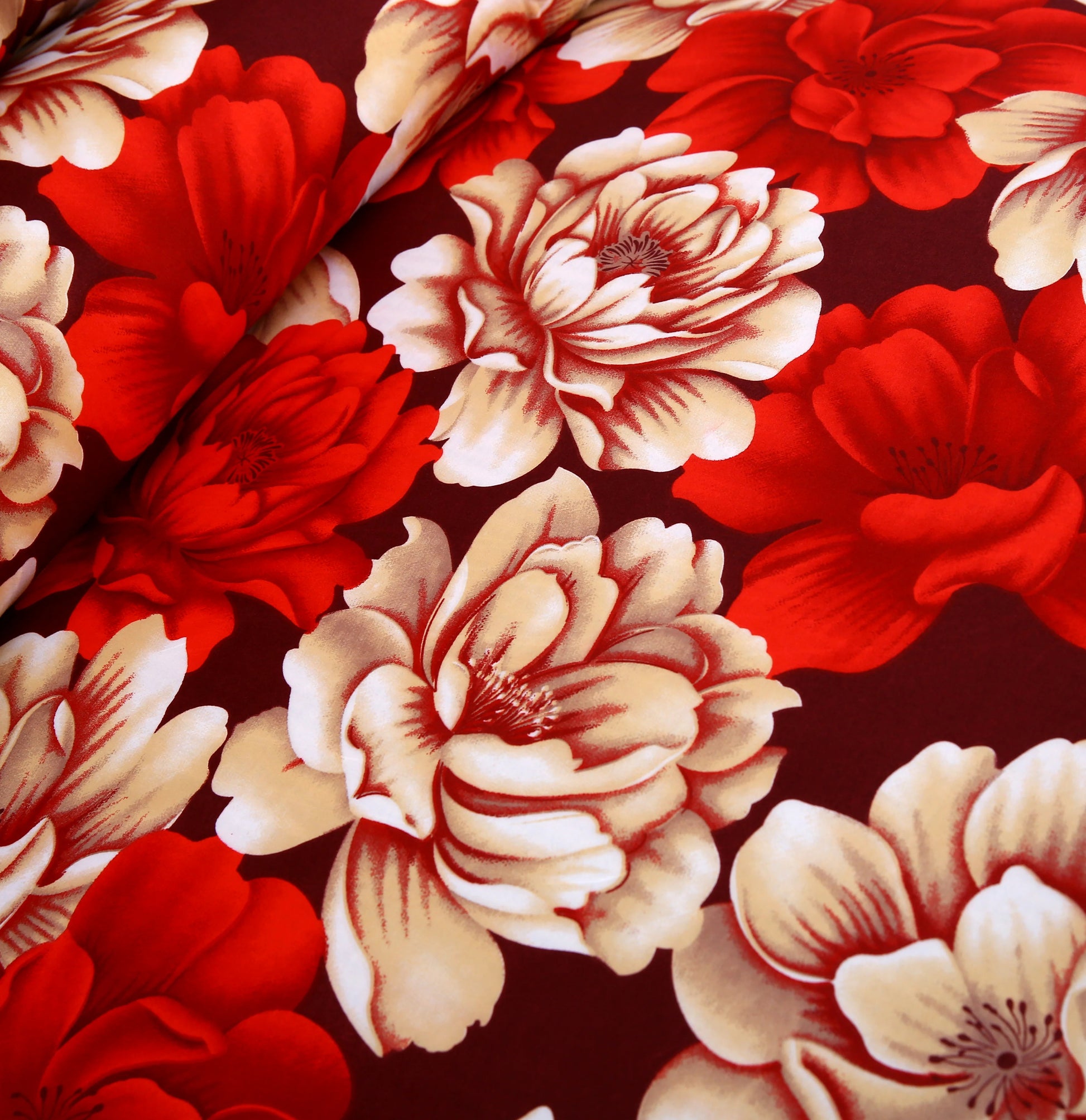 Pattern of red and beige flowers on a dark background