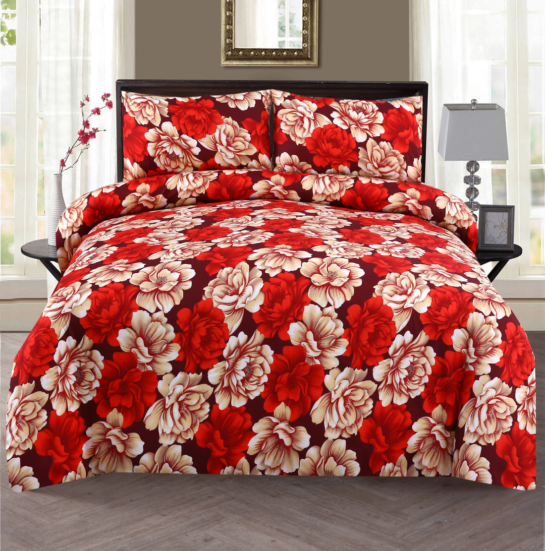 Floral bedding set with red and beige flowers on a bed in a bedroom.