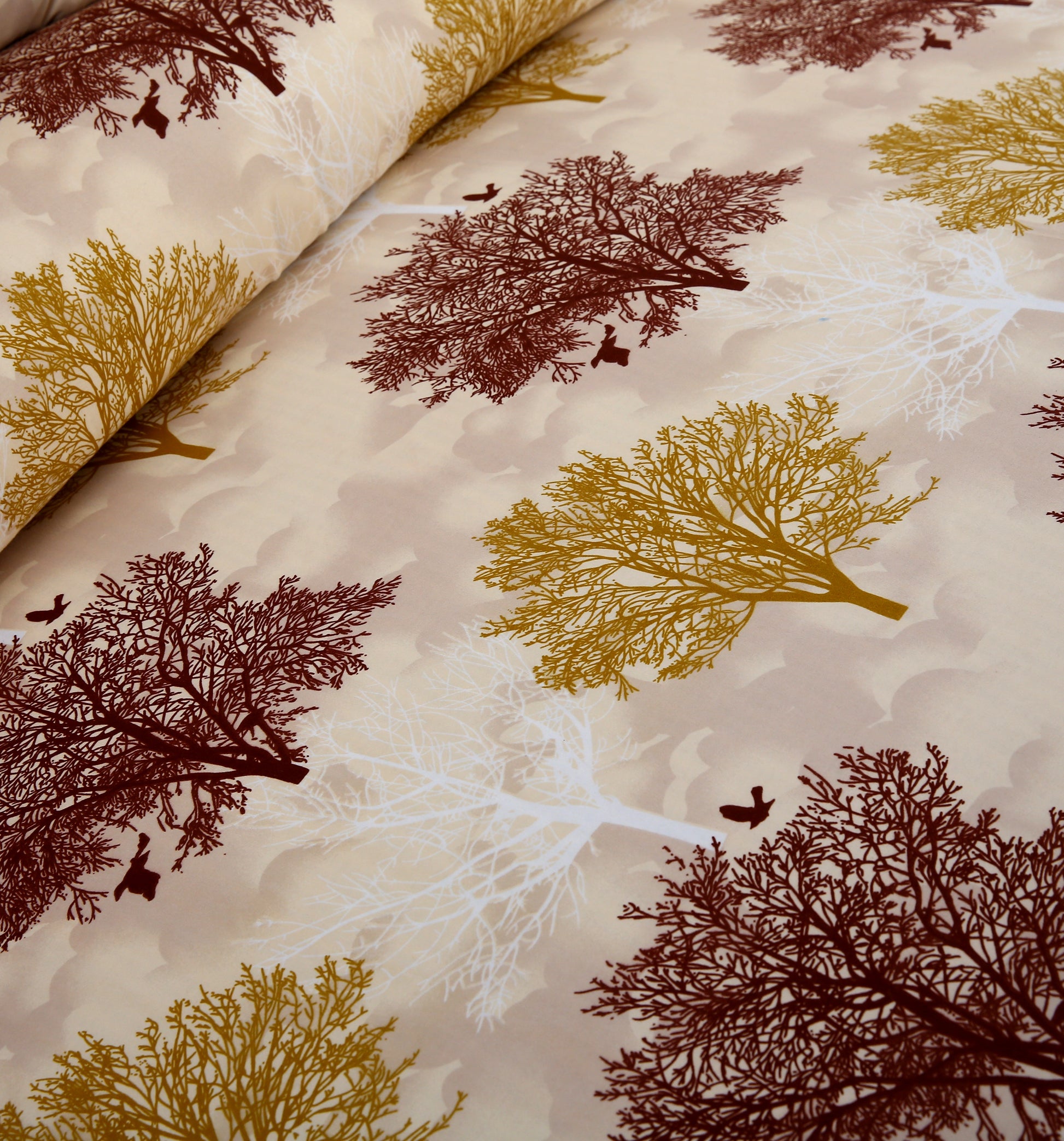 Fabric with tree and leaf pattern on a beige background