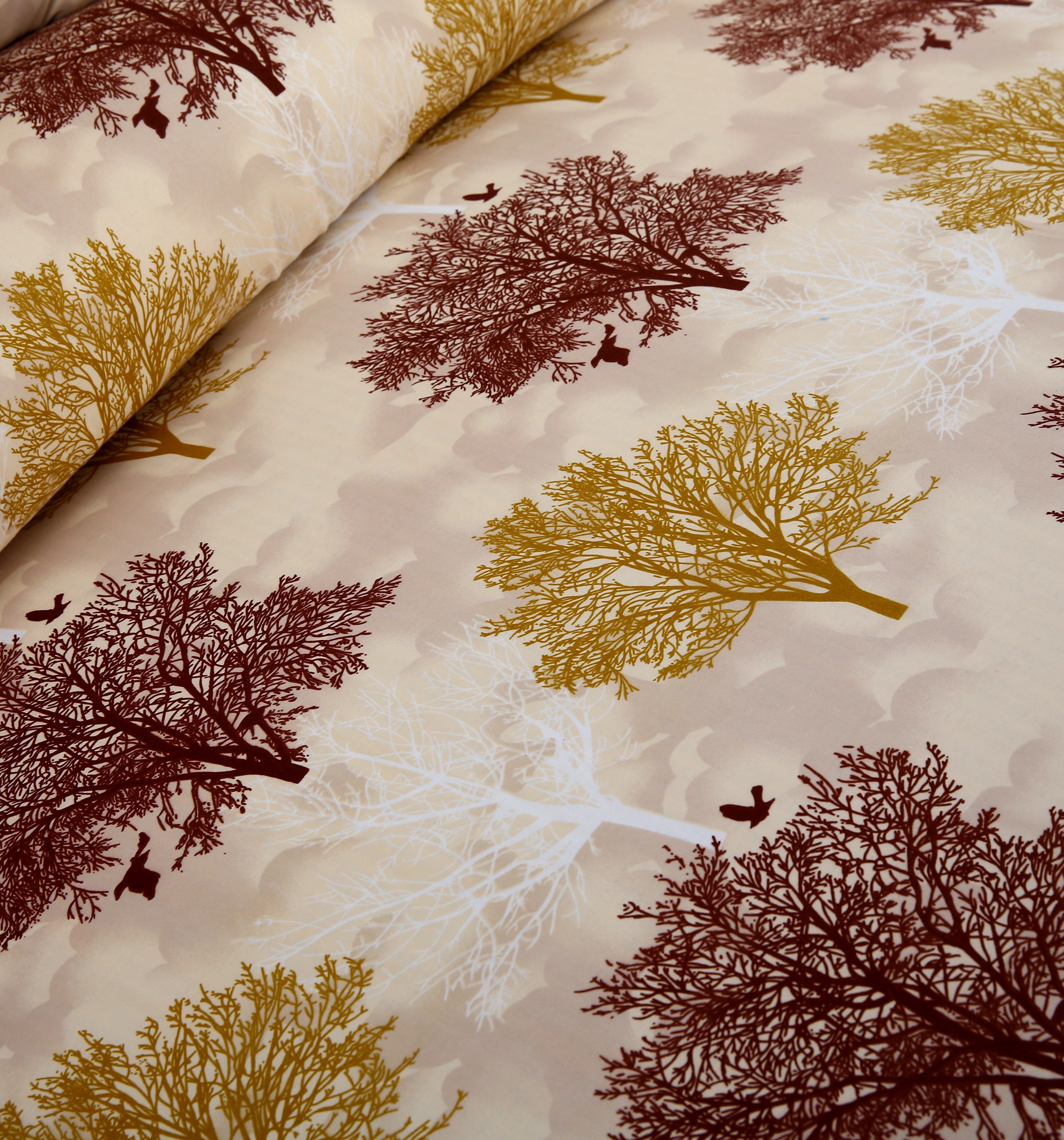 Fabric with tree and leaf pattern on a beige background