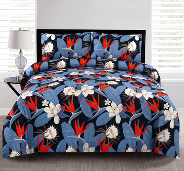 Floral patterned bedding set on a bed with a lamp and window in the background.