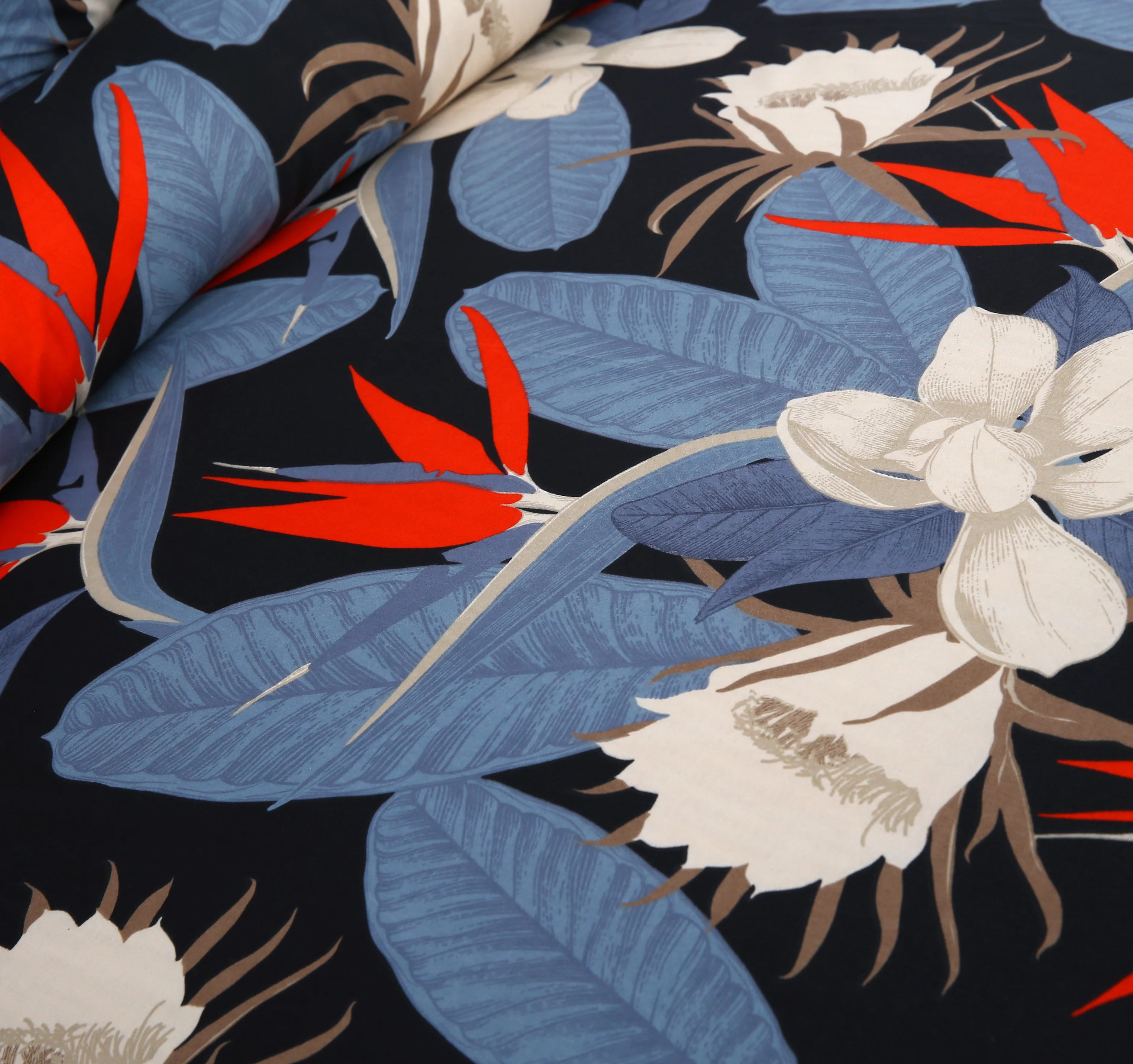 Tropical floral pattern with red, blue, and white flowers on a black background