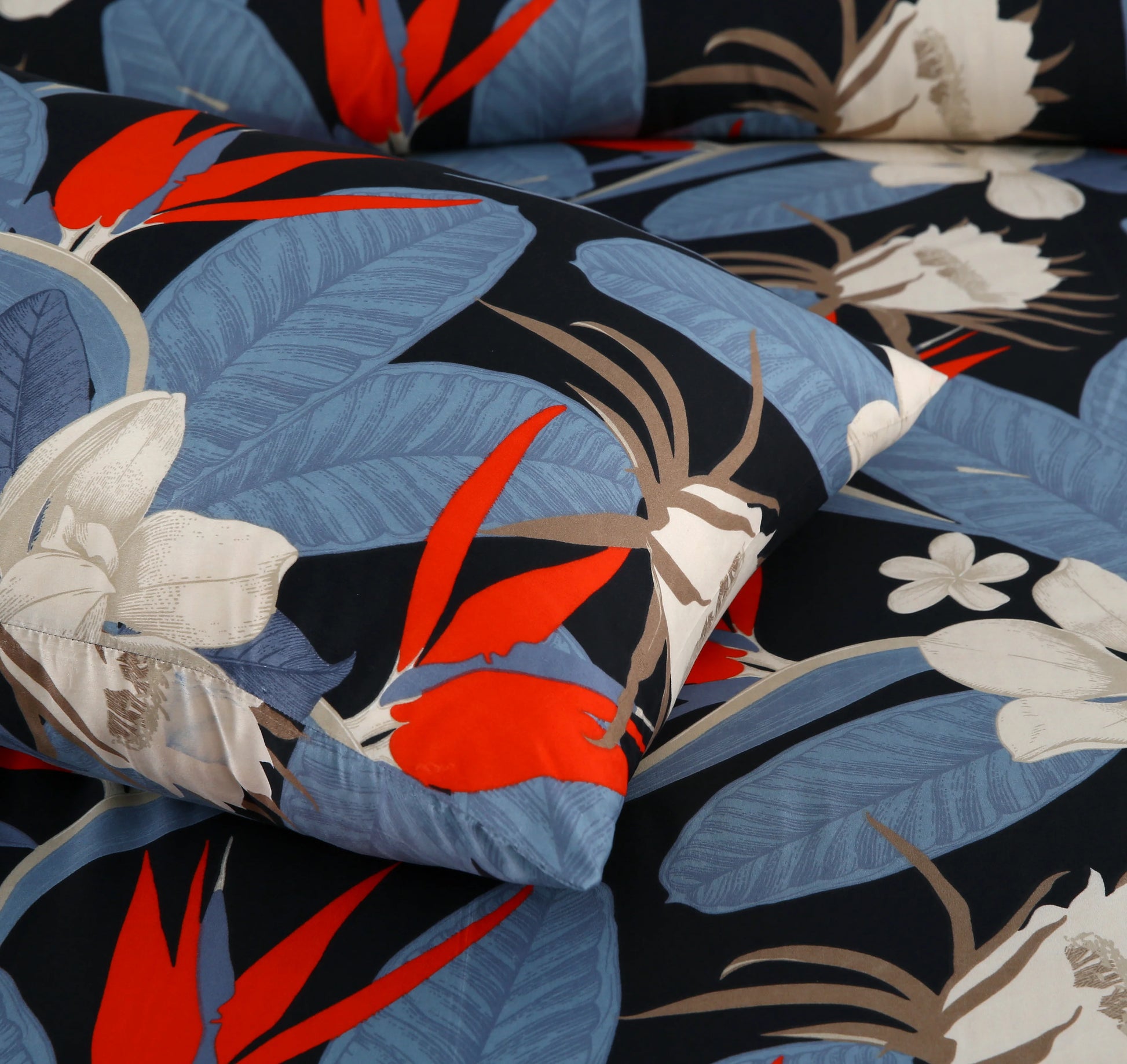 Close-up of floral fabric with red, blue, and white flowers on a black background
