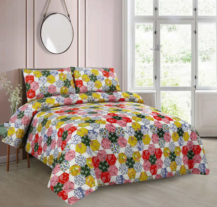 Floral quilt set on a bed in a bright bedroom with large windows.