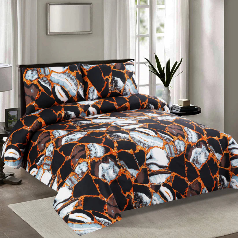 Bedding set with a black, orange, and white pattern in a bedroom setting.