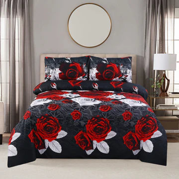 Bedding set with red roses on a bed in a bedroom setting.