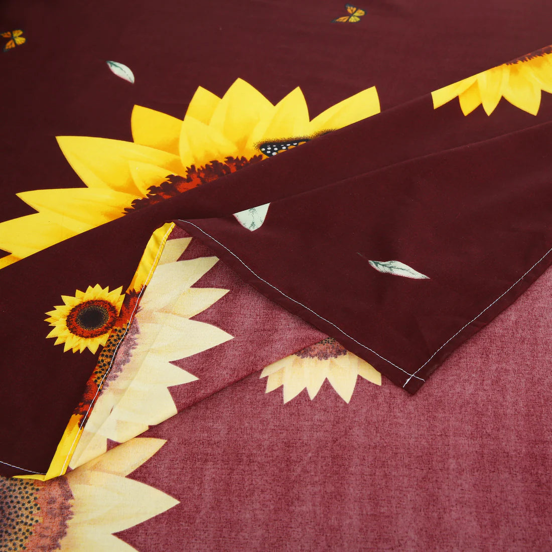 Sunflower patterned bedding set on a bed in a bedroom.