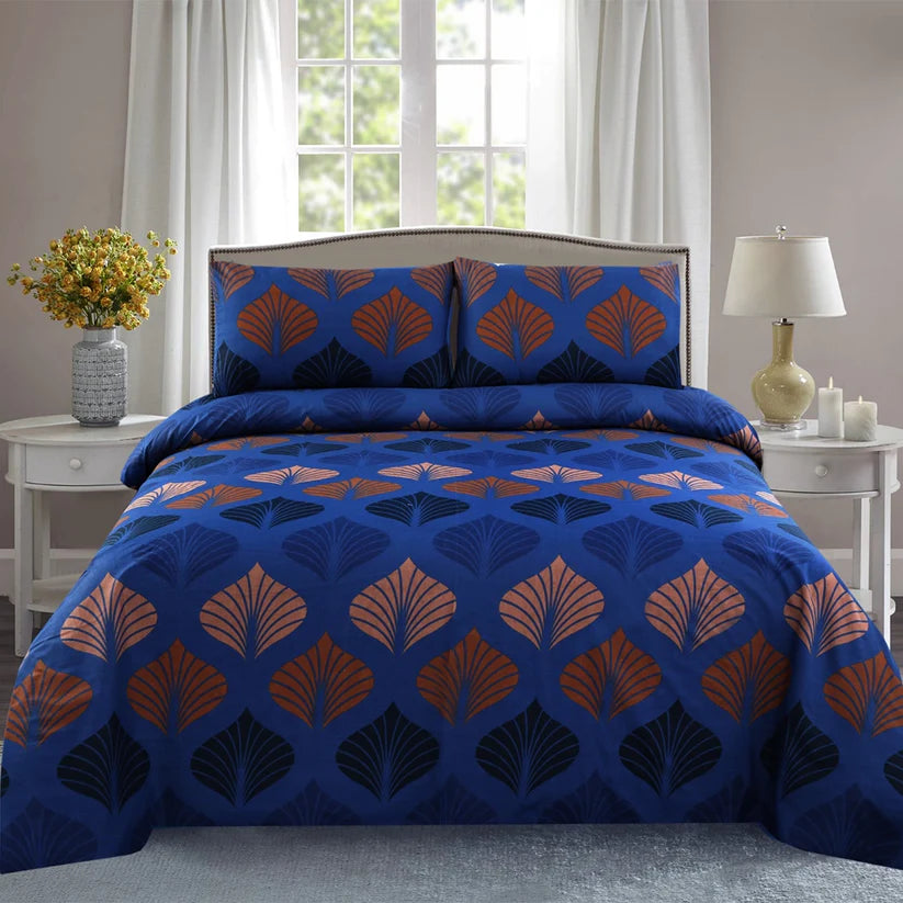 Blue and orange patterned bedding set on a bed in a bedroom with side tables and decor.