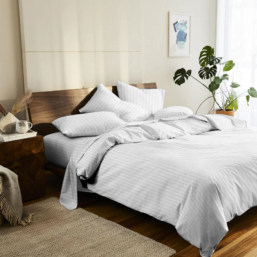 Bedroom with white bedding and wooden headboard