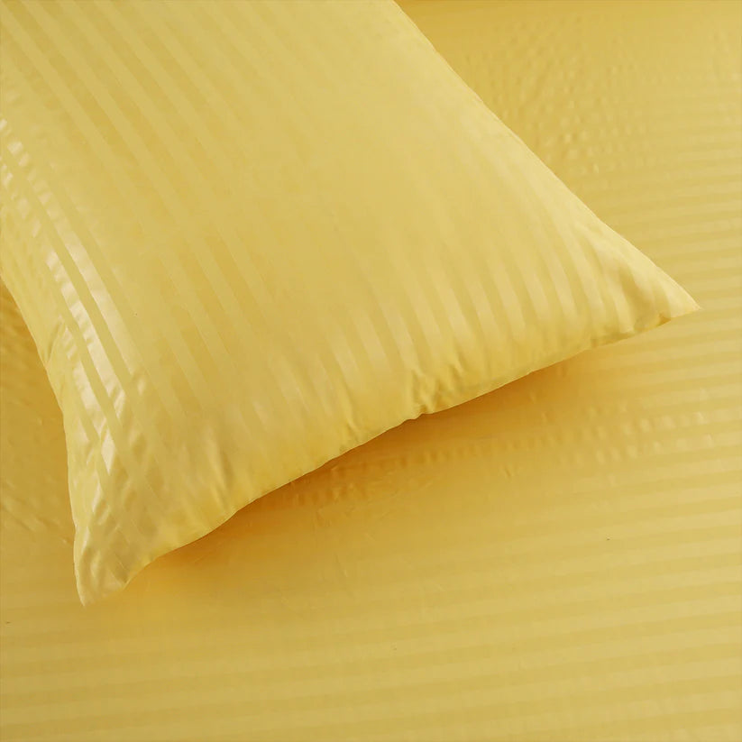 Yellow textured fabric with a pillow on top